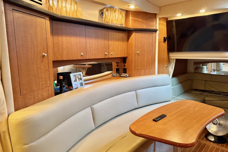  Yacht Photos Pics Luxurious interior of 2006 Sea Ray 340 Sundancer yacht with wood cabinetry and plush seating.