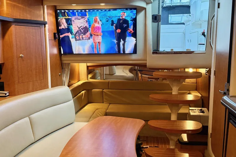  Yacht Photos Pics Luxurious 2006 Sea Ray 340 Sundancer interior with TV, leather seating, and wooden accents.