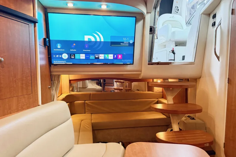  Yacht Photos Pics Interior of 2006 Sea Ray 340 Sundancer yacht with modern TV and cozy seating area.