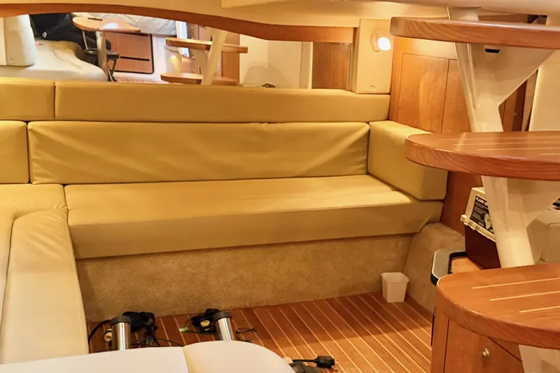  Yacht Photos Pics Interior of 2006 Sea Ray 340 Sundancer with beige seating and wooden accents.