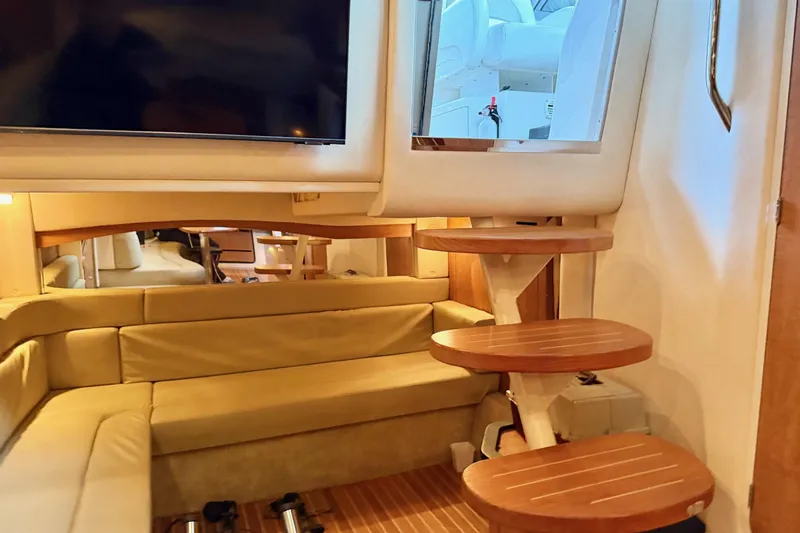  Yacht Photos Pics Interior of 2006 Sea Ray 340 Sundancer with wooden steps and beige seating area.