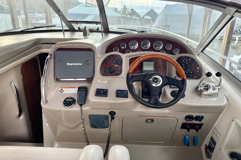 Yacht Photos Pics 2006 Sea Ray 340 Sundancer helm with Raymarine navigation system and classic wood accents.