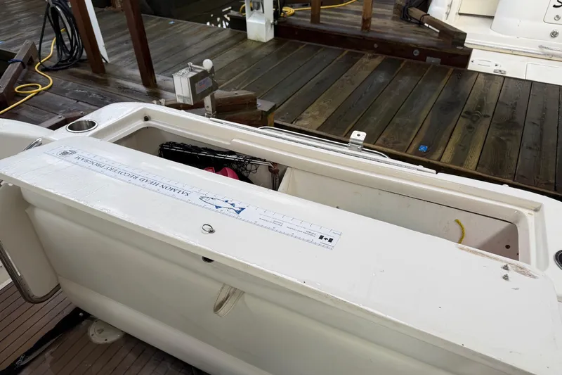  Yacht Photos Pics 2006 Sea Ray 340 Sundancer boat with open storage compartment on wooden dock.