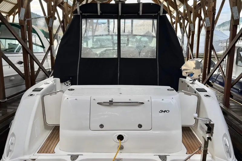  Yacht Photos Pics 2006 Sea Ray 340 Sundancer docked in a covered marina, rear view.