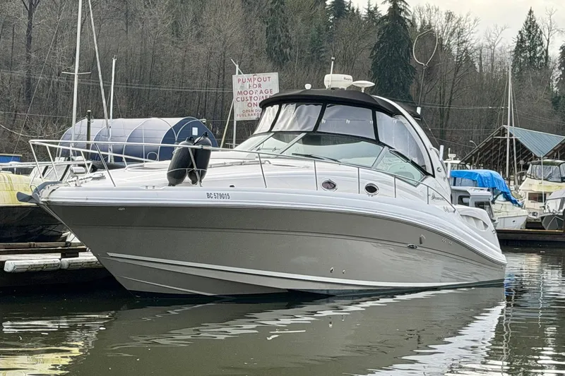  Yacht Photos Pics 2006 Sea Ray 340 Sundancer yacht docked in a marina, surrounded by trees.