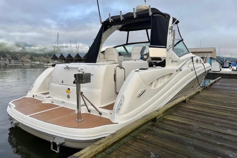  Yacht Photos Pics 2006 Sea Ray 340 Sundancer docked at marina, showcasing sleek design and spacious deck.