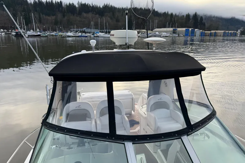  Yacht Photos Pics 2006 Sea Ray 340 Sundancer boat docked on a calm lake with forested background.