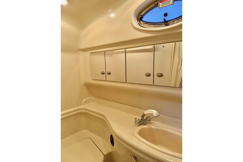  Yacht Photos Pics 2006 Sea Ray 340 Sundancer bathroom with sink, mirror, and storage cabinets.