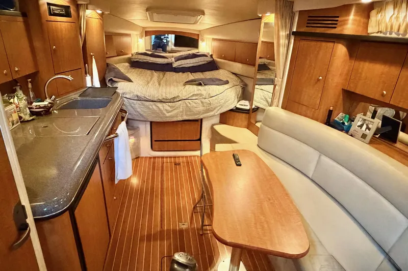  Yacht Photos Pics Luxurious 2006 Sea Ray 340 Sundancer cabin interior with cozy bed, kitchenette, and seating area.
