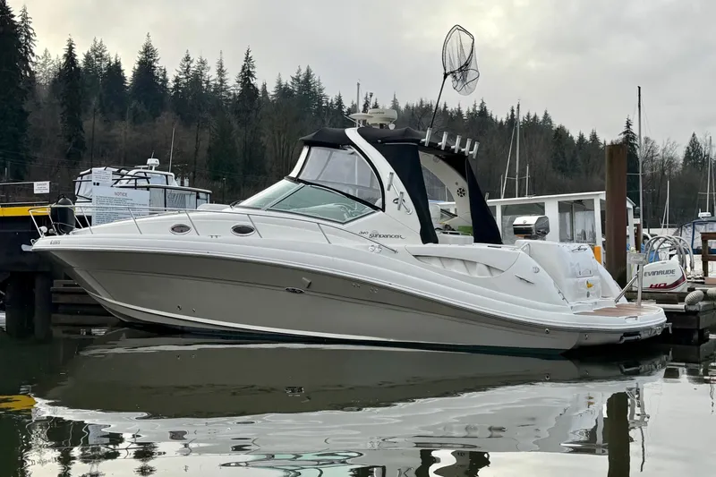  Yacht Photos Pics 2006 Sea Ray 340 Sundancer yacht docked in a serene marina setting.