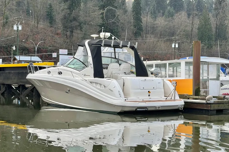  Yacht Photos Pics 2006 Sea Ray 340 Sundancer docked in a serene marina setting.