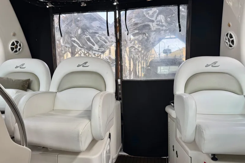  Yacht Photos Pics Interior of 2006 Sea Ray 340 Sundancer with white leather seating and clear windows.