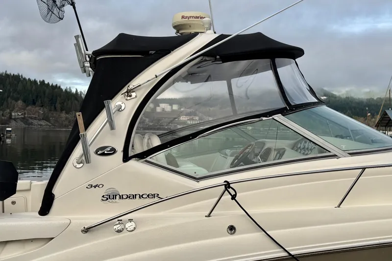  Yacht Photos Pics 2006 Sea Ray 340 Sundancer boat docked with black canopy and scenic background.