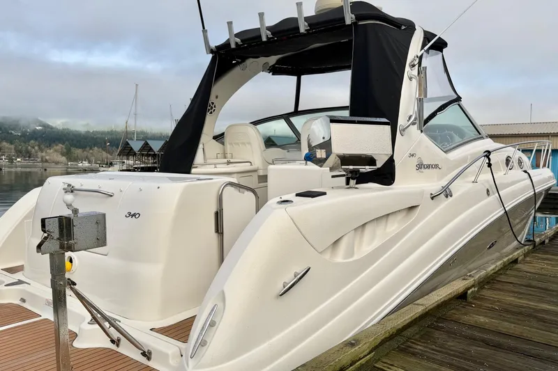 Yacht Photos Pics 2006 Sea Ray 340 Sundancer docked, showcasing sleek design and spacious deck.