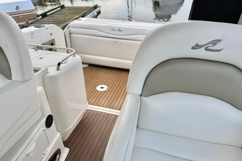  Yacht Photos Pics 2006 Sea Ray 340 Sundancer boat interior with white seating and wood flooring.