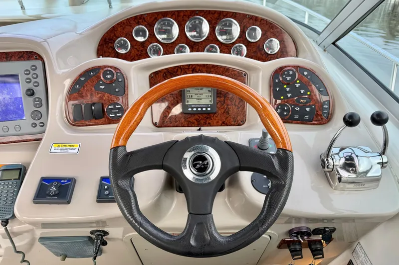  Yacht Photos Pics Helm of 2006 Sea Ray 340 Sundancer with wood accents and modern controls.