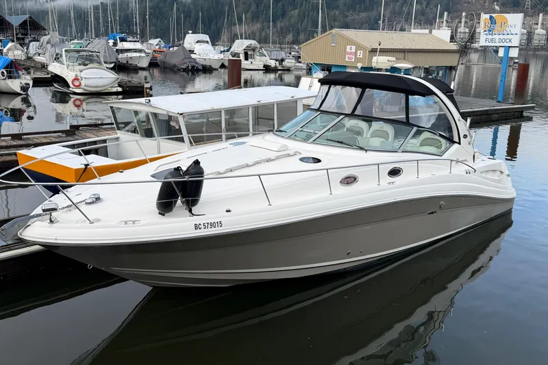  Yacht Photos Pics 2006 Sea Ray 340 Sundancer docked at marina with other boats in background.
