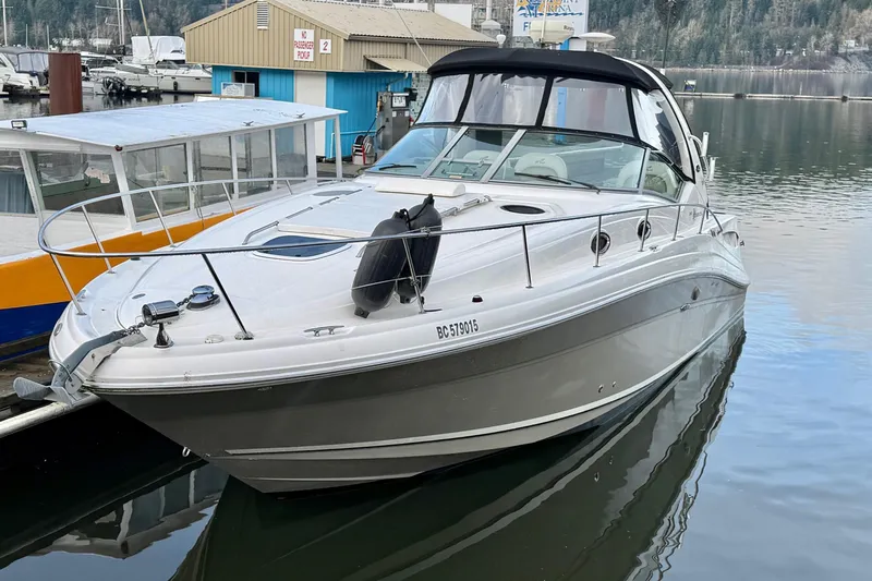  Yacht Photos Pics 2006 Sea Ray 340 Sundancer docked at marina, sleek design, calm waters.