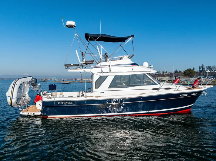 Awol Yacht Photos Pics 2016 Cutwater 30 Command Bridge boat on water, blue hull, sunny day.