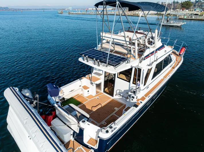 Awol Yacht Photos Pics 2016 Cutwater 30 Command Bridge boat on water, featuring spacious deck and modern design.