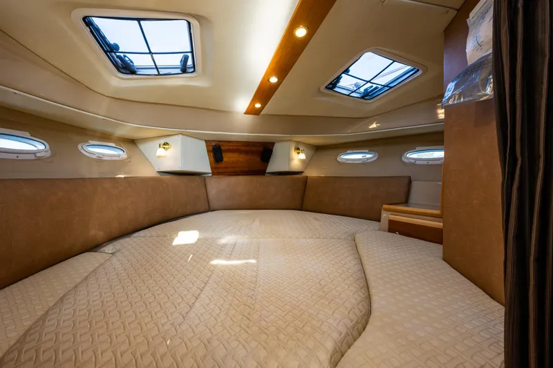 Awol Yacht Photos Pics Interior cabin of 2016 Cutwater 30 Command Bridge, featuring skylights and cozy bedding.