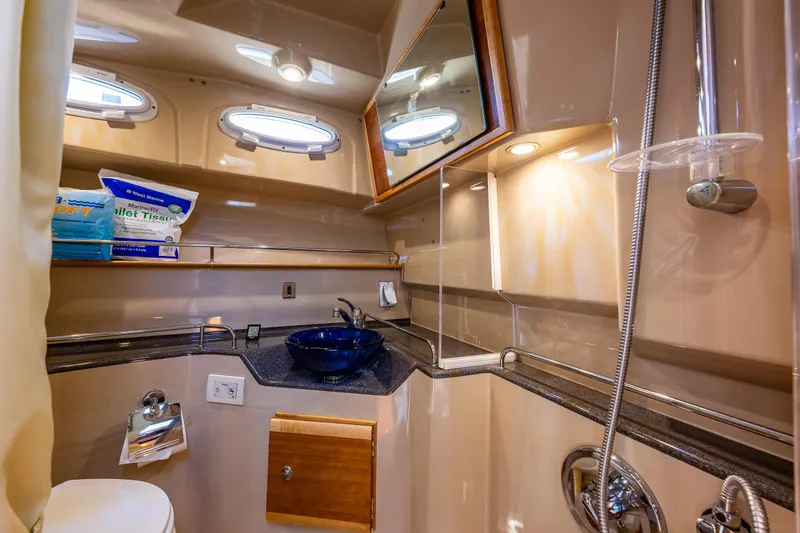 Awol Yacht Photos Pics 2016 Cutwater 30 Command Bridge bathroom with modern fixtures and porthole windows.