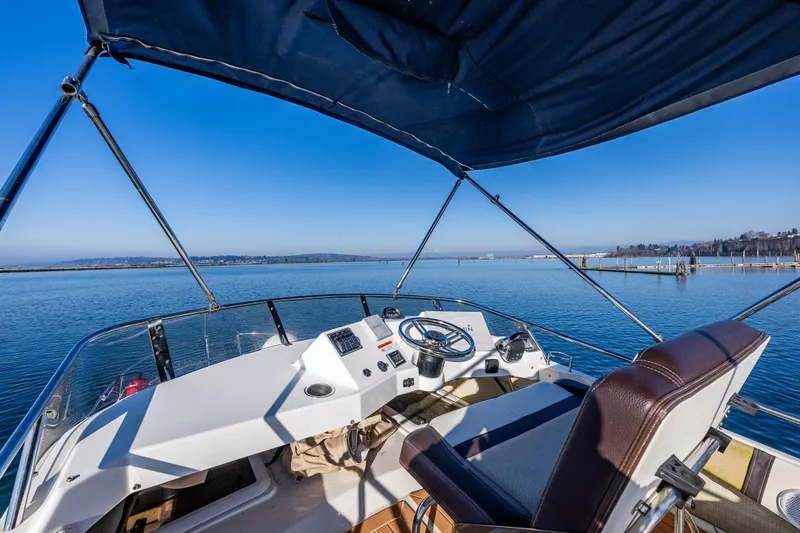 Awol Yacht Photos Pics Helm of 2016 Cutwater 30 Command Bridge overlooking serene waters.