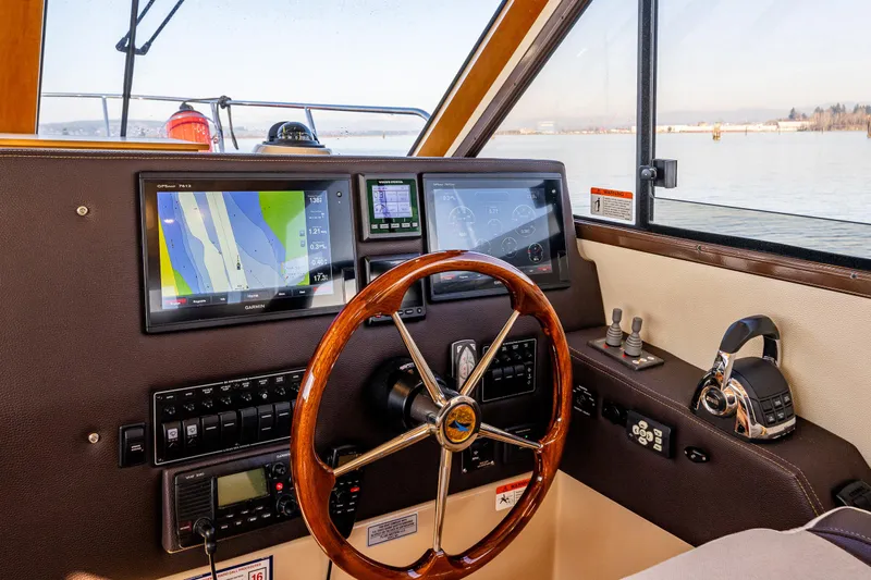 Awol Yacht Photos Pics Helm of 2016 Cutwater 30 Command Bridge with navigation screens and steering wheel.