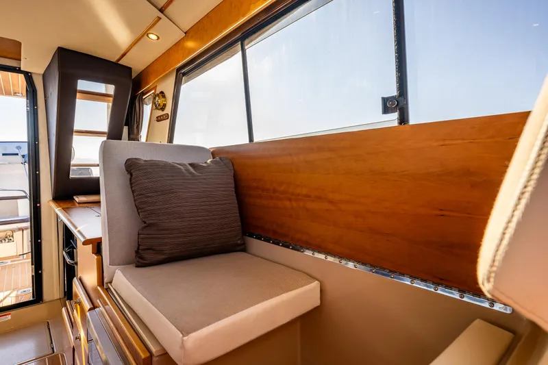 Awol Yacht Photos Pics Interior of 2016 Cutwater 30 Command Bridge, featuring cushioned seating and wooden accents.