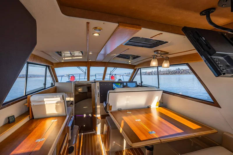 Awol Yacht Photos Pics Interior of 2016 Cutwater 30 Command Bridge, featuring wood accents and panoramic windows.