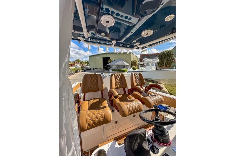  Yacht Photos Pics Interior of 2022 Invincible 39 Open Fisherman boat with luxurious seating and steering wheel.