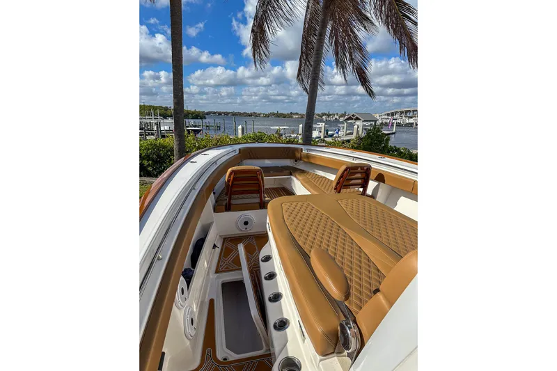  Yacht Photos Pics 2022 Invincible 39 Open Fisherman boat with luxurious seating, docked by a scenic waterfront.