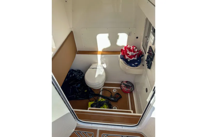  Yacht Photos Pics 2022 Invincible 39 Open Fisherman boat interior with toilet and storage items.