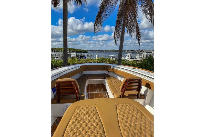  Yacht Photos Pics 2022 Invincible 39 Open Fisherman boat with luxurious seating, docked by a scenic waterfront.