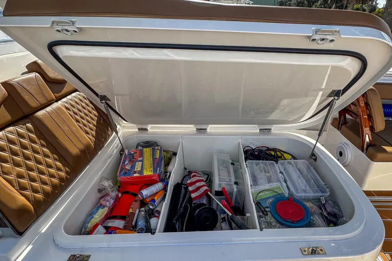  Yacht Photos Pics Storage compartment of 2022 Invincible 39 Open Fisherman boat, filled with fishing gear and supplies.