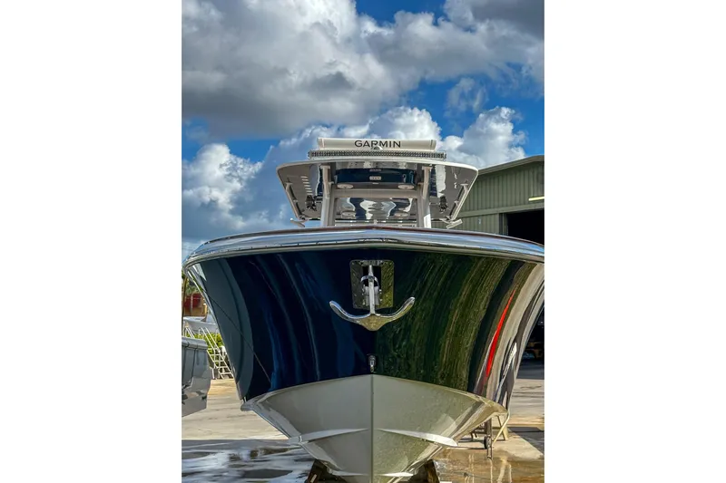  Yacht Photos Pics 2022 Invincible 39 Open Fisherman boat with Garmin equipment, docked under a cloudy sky.