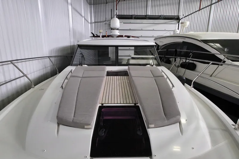  Yacht Photos Pics 2014 Jeanneau NC 14 yacht with cushioned deck, stored indoors.