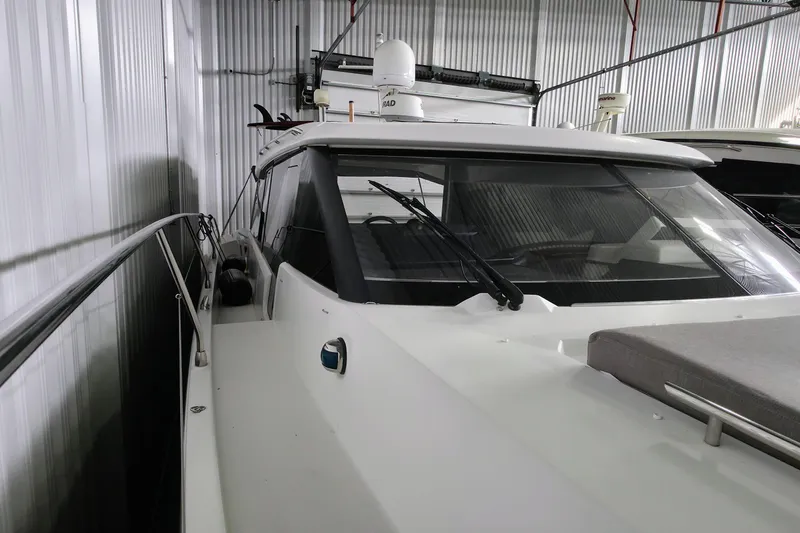  Yacht Photos Pics 2014 Jeanneau NC 14 yacht in storage, showcasing sleek design and modern features.