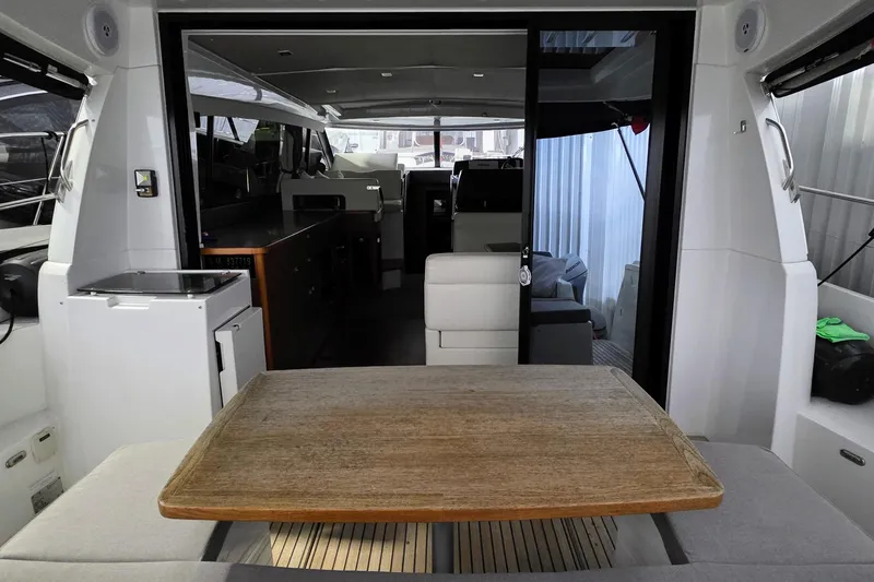  Yacht Photos Pics Interior view of 2014 Jeanneau NC 14 yacht with dining area and modern design.