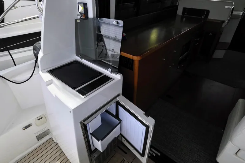  Yacht Photos Pics 2014 Jeanneau NC 14 yacht interior with open storage compartments and sleek design.