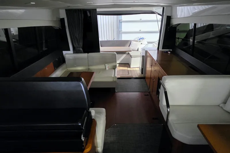  Yacht Photos Pics Interior of 2014 Jeanneau NC 14 yacht with modern seating and wooden cabinetry.