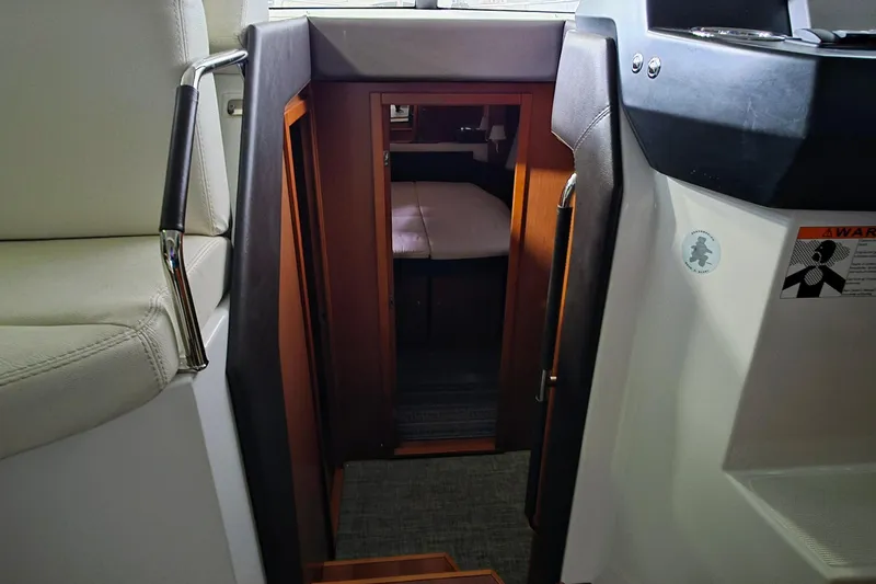  Yacht Photos Pics Interior view of 2014 Jeanneau NC 14 boat cabin entrance with seating.