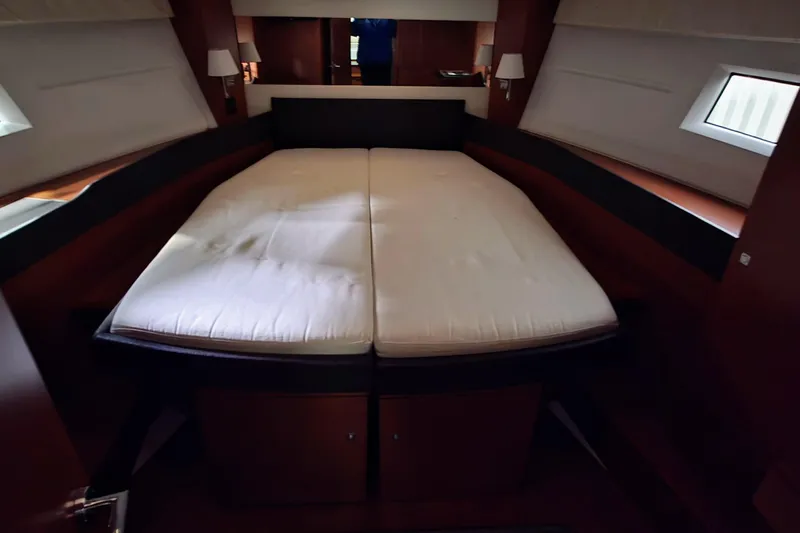 Yacht Photos Pics Luxurious cabin interior of 2014 Jeanneau NC 14 yacht with comfortable bedding.