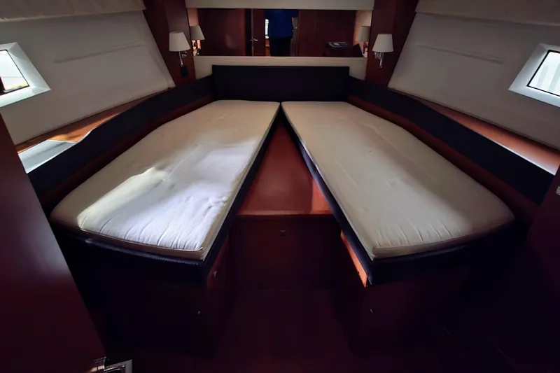  Yacht Photos Pics Luxurious cabin interior of 2014 Jeanneau NC 14 yacht with twin beds.