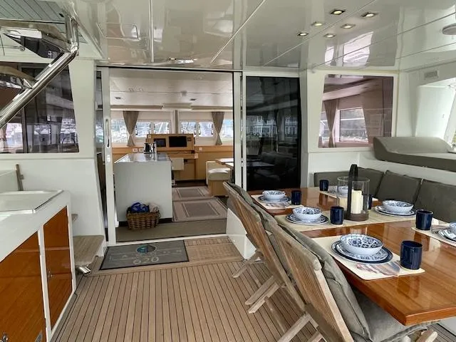 Phoenicia Yacht Photos Pics Interior of a 2014 Lagoon 620 yacht with set dining table.