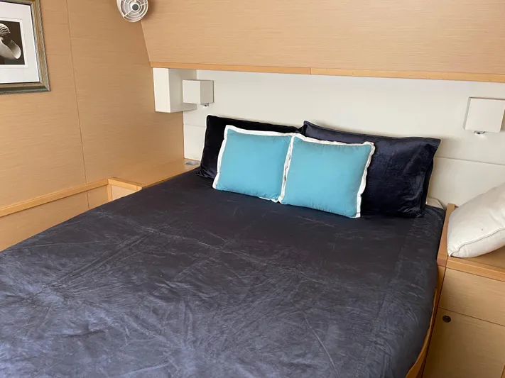 Phoenicia Yacht Photos Pics Interior of Lagoon 620 yacht, cozy bedroom with blue pillows, 2014 model.