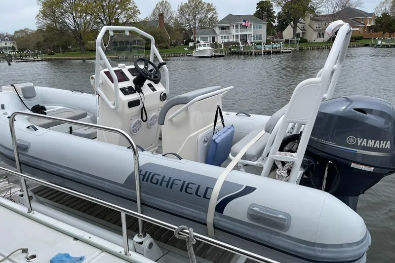 Phoenicia Yacht Photos Pics Highfield inflatable boat with Yamaha engine docked near waterfront homes.