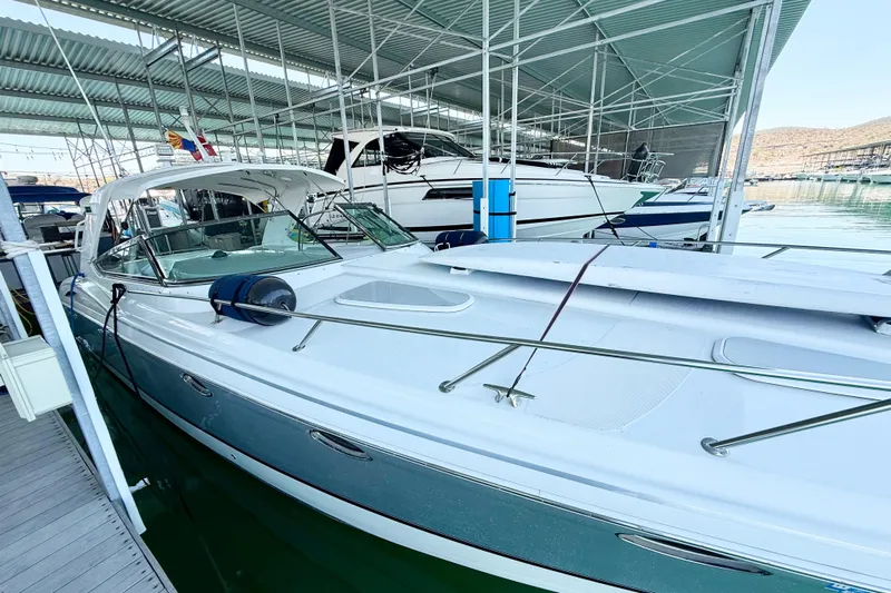 Obstreperous Yacht Photos Pics 2004 Formula 400 Super Sport boat docked in a marina under a covered structure.