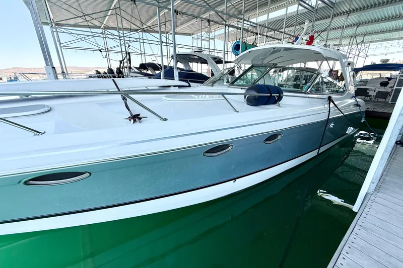 Obstreperous Yacht Photos Pics 2004 Formula 400 Super Sport boat docked in a marina under a covered structure.