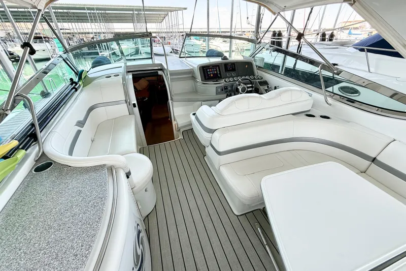 Obstreperous Yacht Photos Pics 2004 Formula 400 Super Sport yacht interior with white seating and modern dashboard.